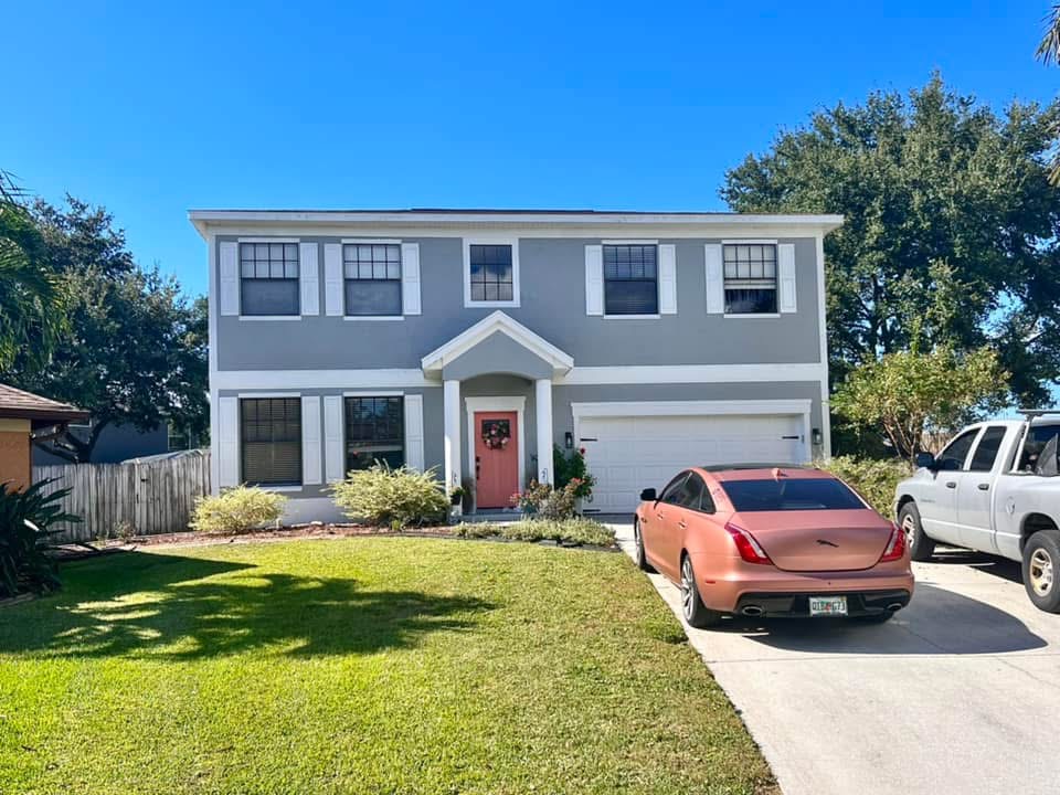 Front yard landscape after renovation with healthy sod, clean beds, shrubs, and curb appeal