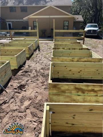 Raised bed irrigation installation in progress with new garden beds and sprinkler piping