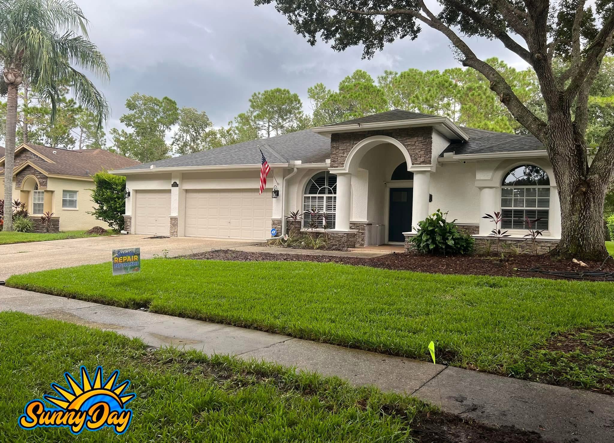 Residential sprinkler repair lawn with fresh green grass, mulch beds, and irrigation flags